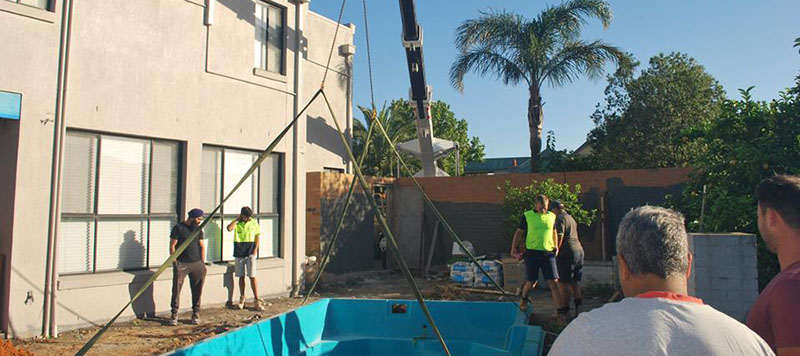 our crane placing pool over the fence