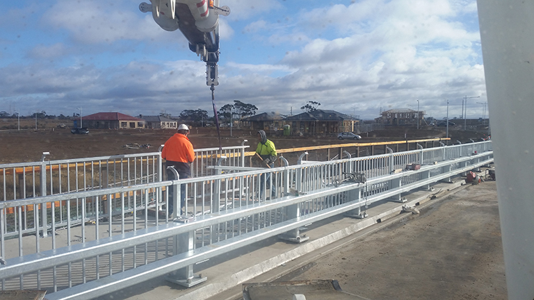 Fitting handrails and guardrails to a bridge in Truganina