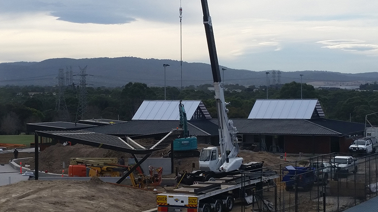 Erect steel for a sports shelter in Wheelers Hill